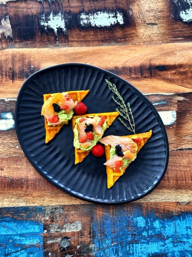Sweet potato waffles with avocado, tomato salsa and smoked salmon